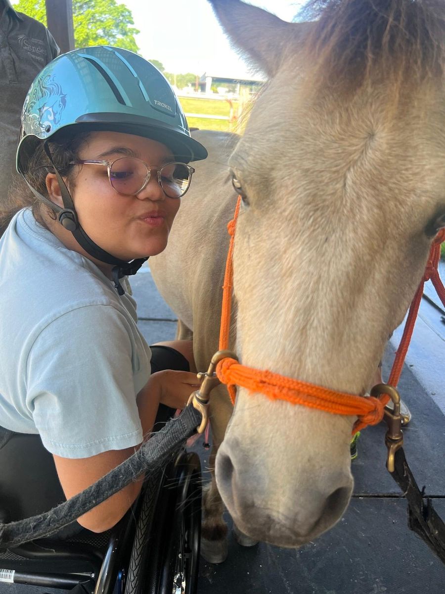 A girl spending time with a horse during a Children’s Kingdom Foundation visit