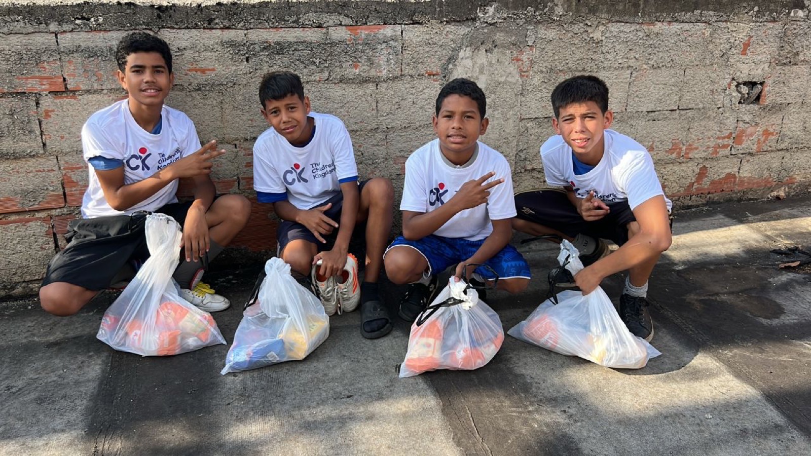 Young people with food supplies during a Nourishing Hope drive