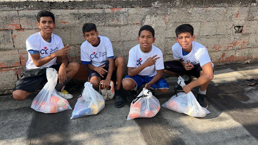 Young people carrying bags of food during a Nourishing Hope food drive in Venezuela