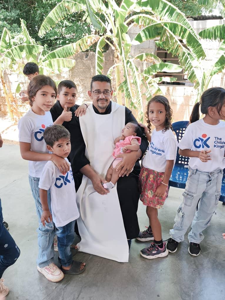 Children and a community leader together in Venezuela